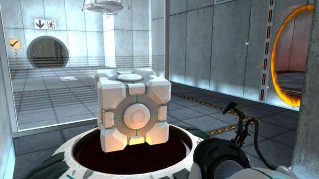 A cube sits on a platform while an orange portal glows on a wall to the right.