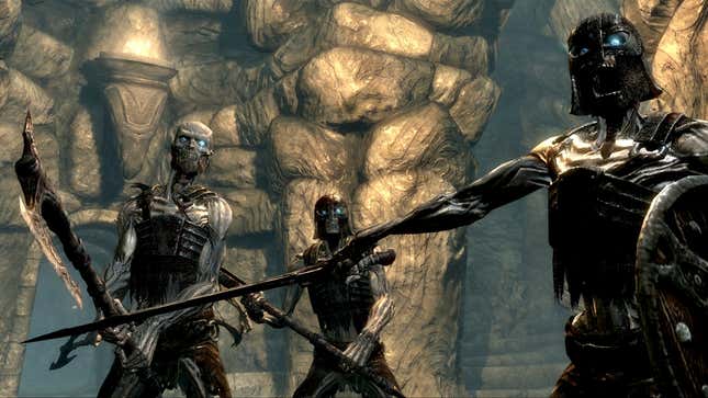 Three skeleton soldiers in The Elder Scrolls V: Skyrim stand ready to attack.