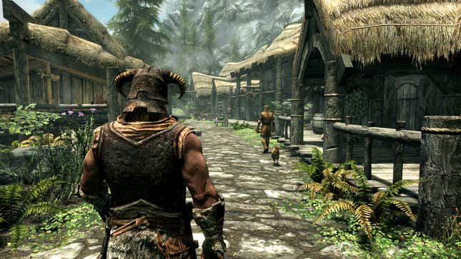 A figure in a horned helmet and armor strides down a wide lane in a fantasy village.